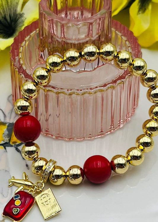 Pulsera con pendant de avión y maleta